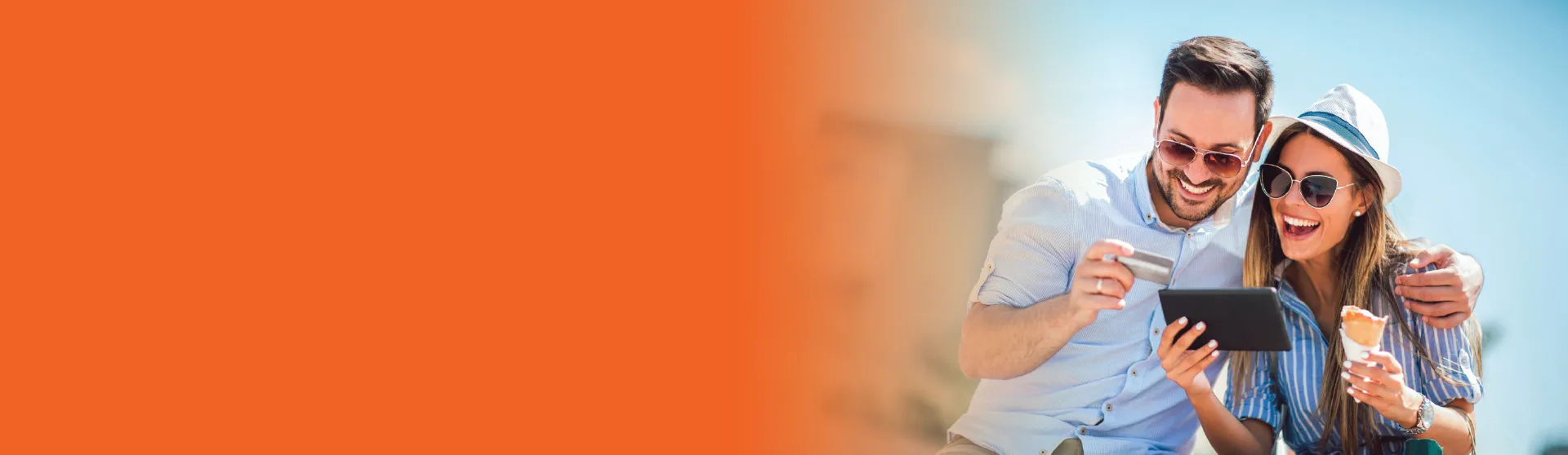 Happy couple on vacation looking at their online banking.